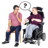 A man in a wheelchair asking a question of another man.