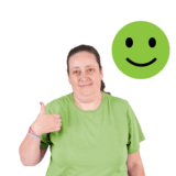 A woman in green with a green smiley emoji, looking happy with a thumbs up.
