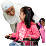 A girl with a pink top and her mother talking.