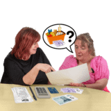 A woman asking about shopping costs with money to another woman on a table.