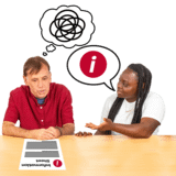 A person not understanding reading and someone helping him.