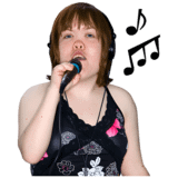 A woman with a microphone and notes around her singing.
