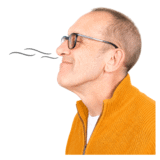 A man with a yellow top smelling with his nose.