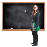 Teacher in front of a blackboard pointing at it.